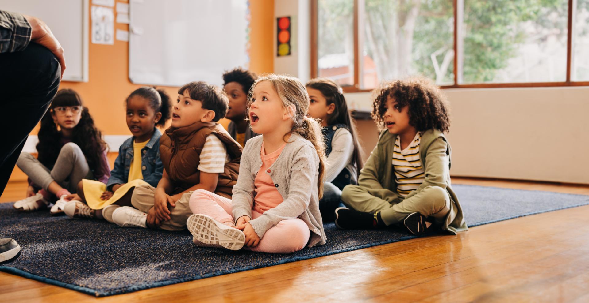 Children in a group receiving a lesson