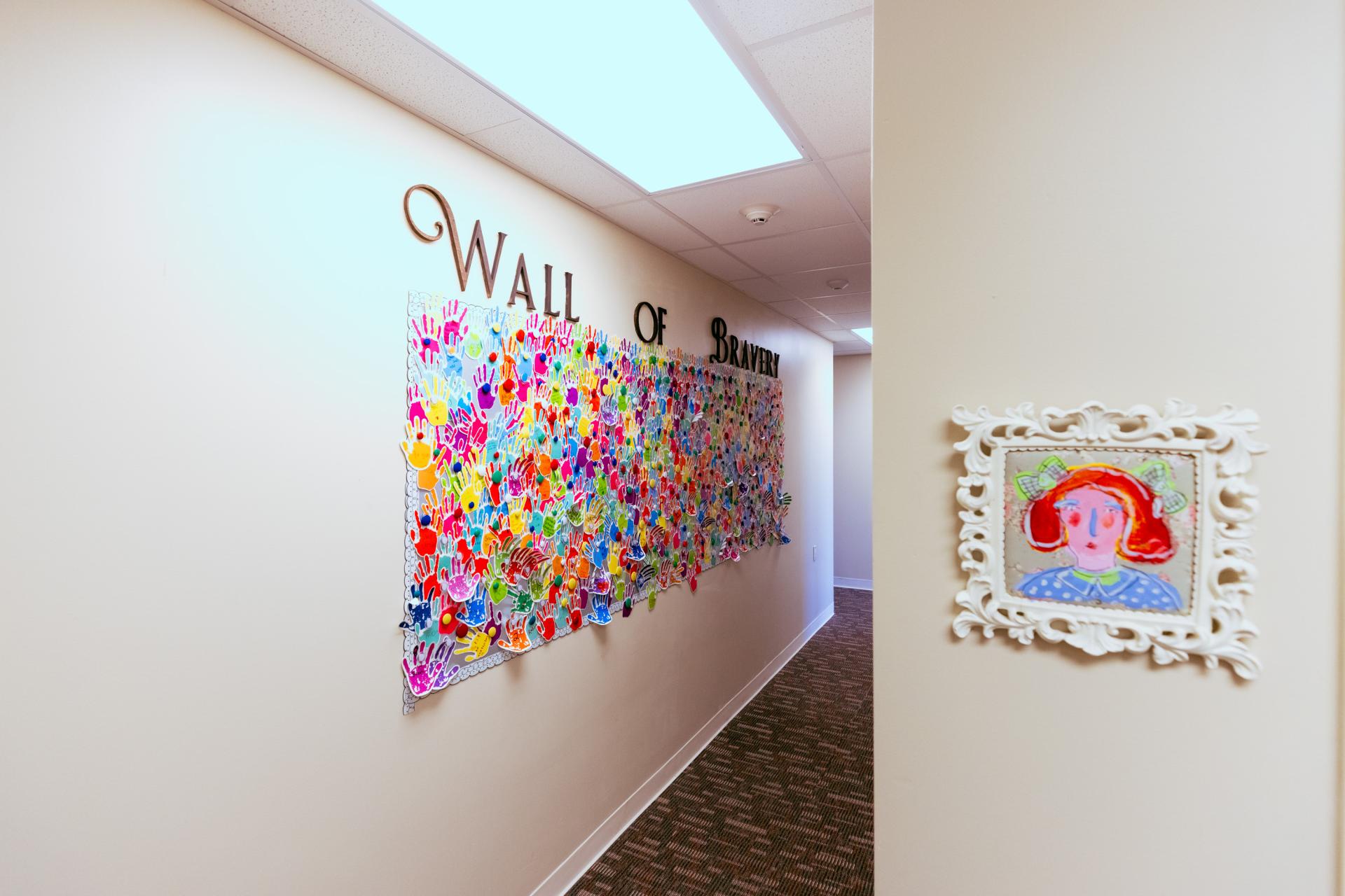 wall at the CAC with commerative handprints from past children