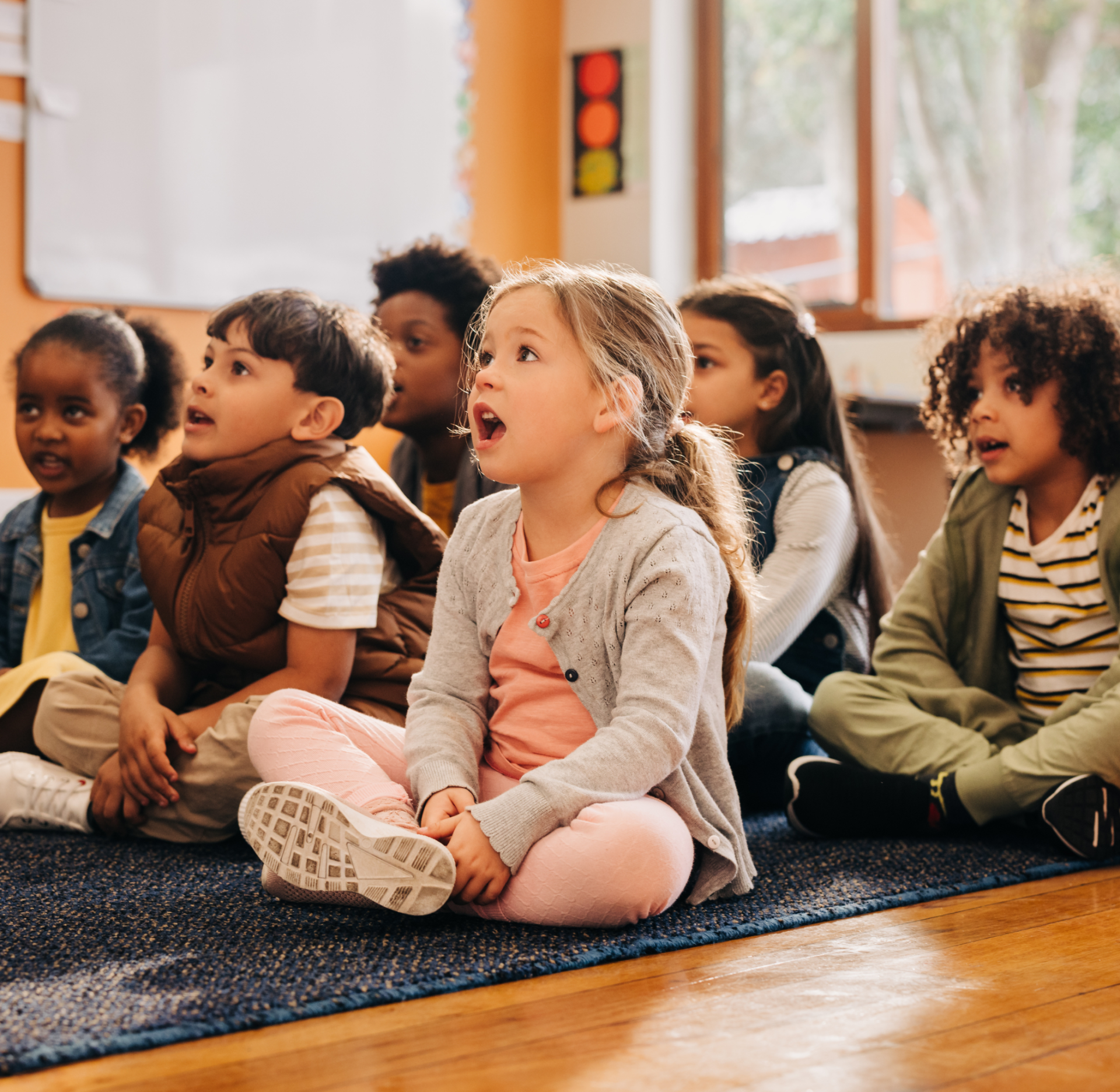 Children in a group receiving a lesson