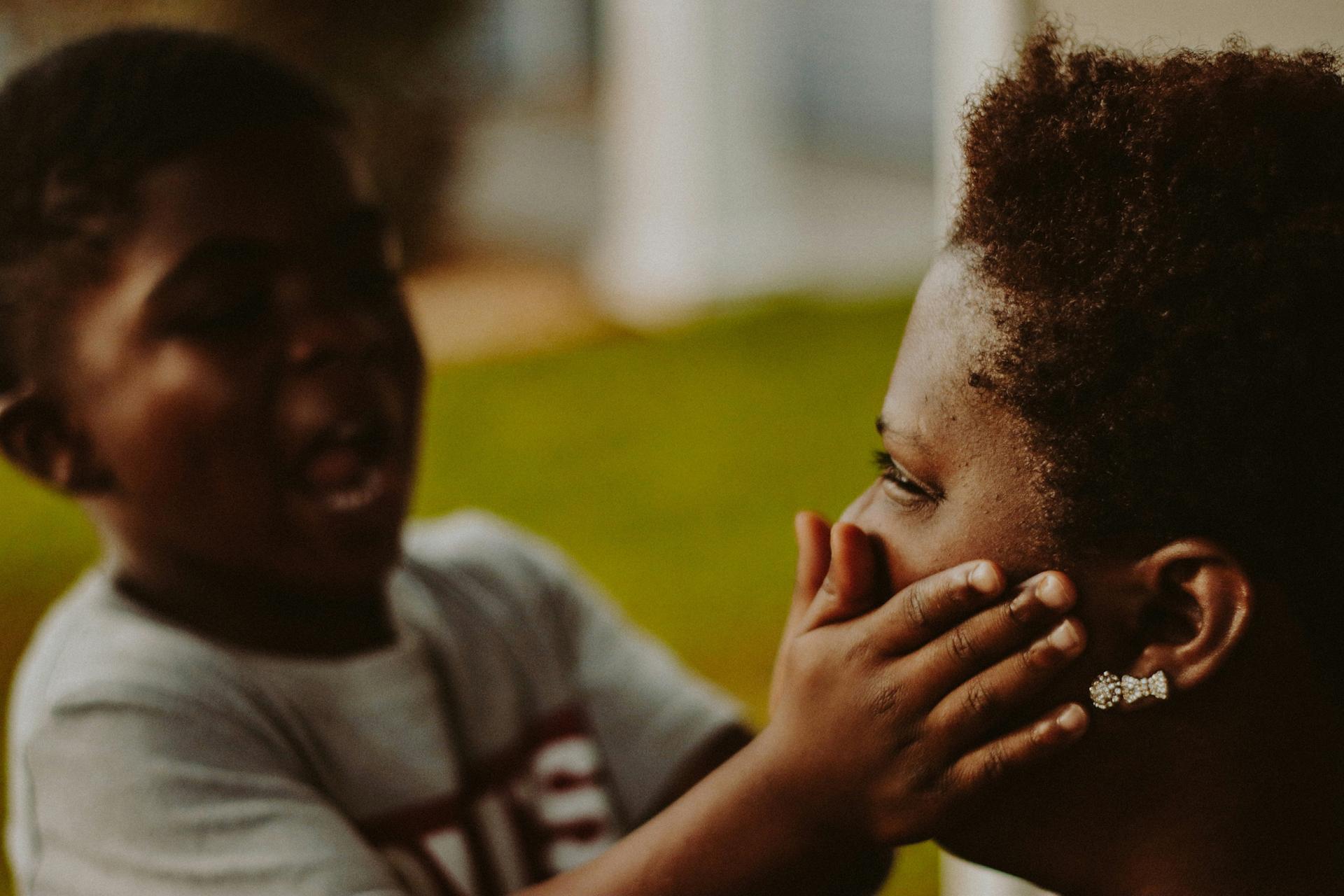 A child playfully holds an adult